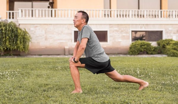 full-shot-man-stretching-nature_23-2148694205